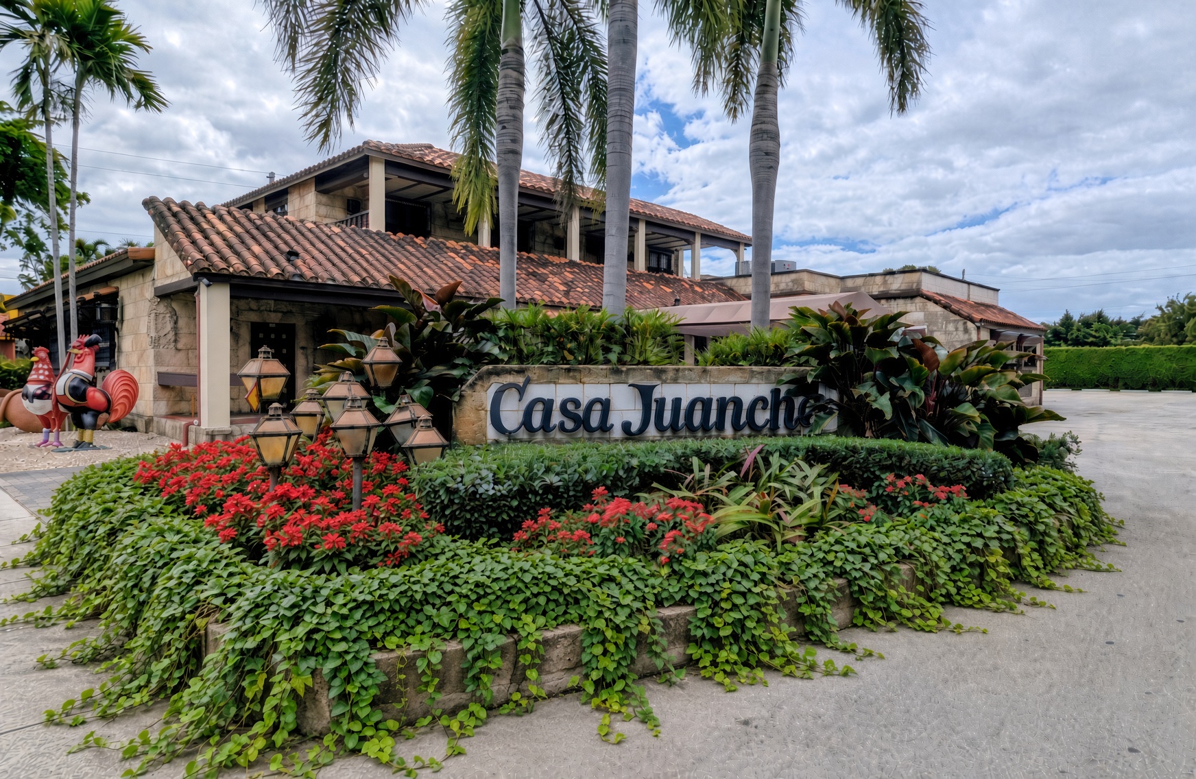 The garden entrance and stone sign of Casa Juancho